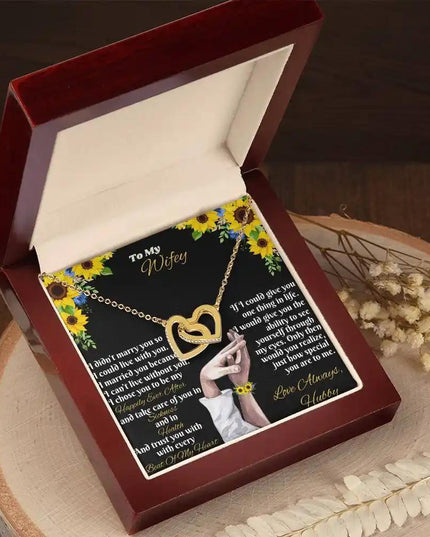 gold interlocking hearts necklace in mahogany box angled left