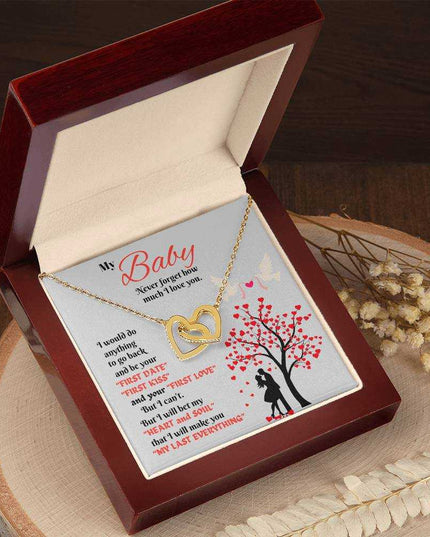 gold interlocking hearts necklace in luxury box angled left