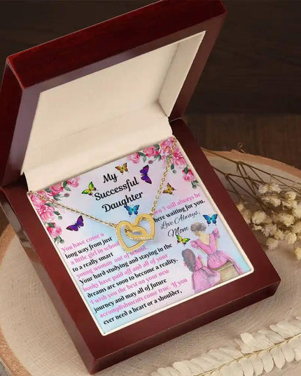 gold interlocking hearts necklace in mahogany box angled left