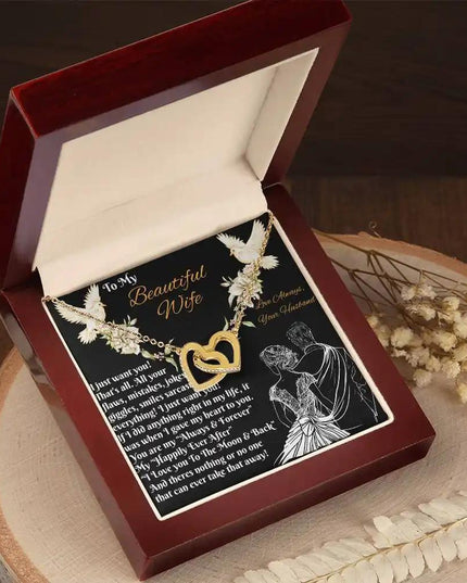 gold interlocking hearts necklace in a mahogany box angled left