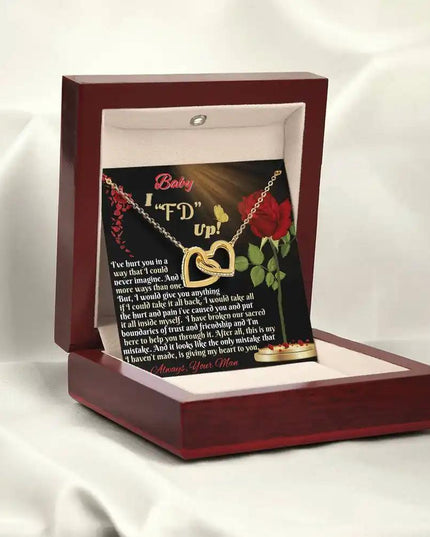 gold interlocking hearts necklace in mahogany box angled left