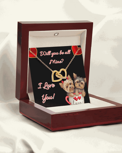 gold interlocking hearts necklace in a mahogany box angled to the left