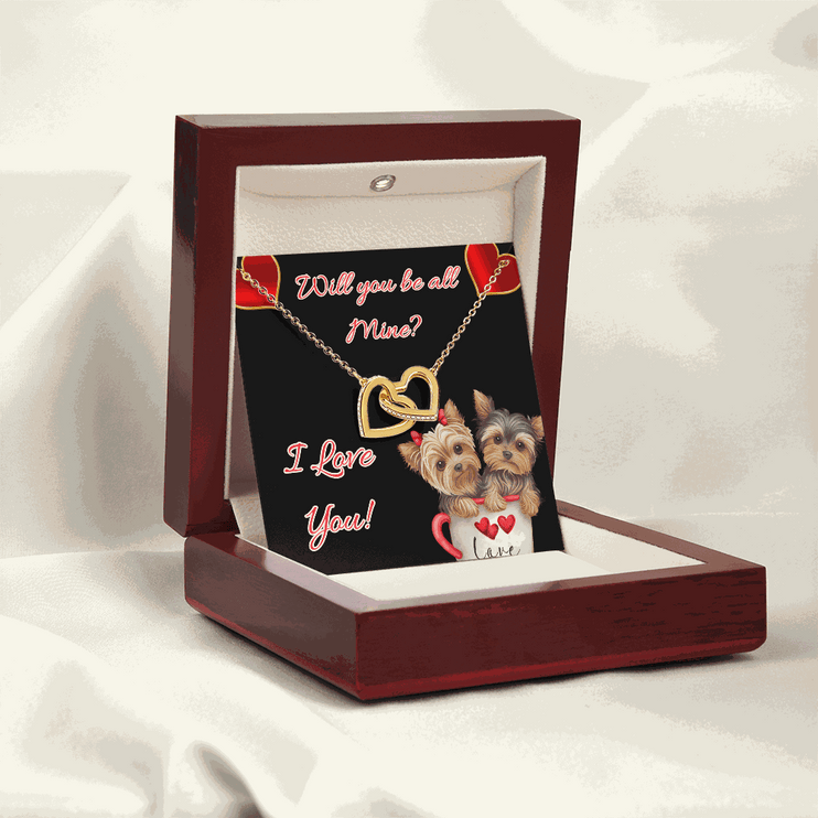 gold interlocking hearts necklace in a mahogany box angled to the left