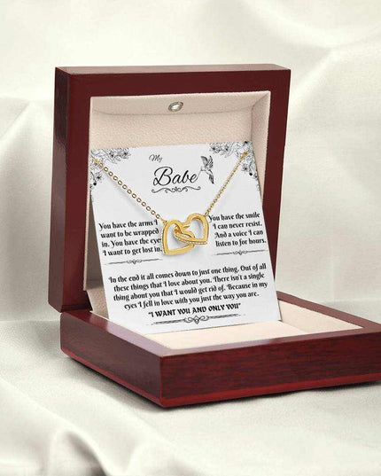 gold interlocking hearts necklace in a luxury box angled to the left