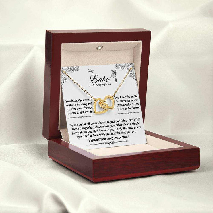 gold interlocking hearts necklace in a luxury box angled to the left