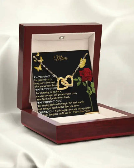 gold interlocking hearts necklace in mahogany box angled left