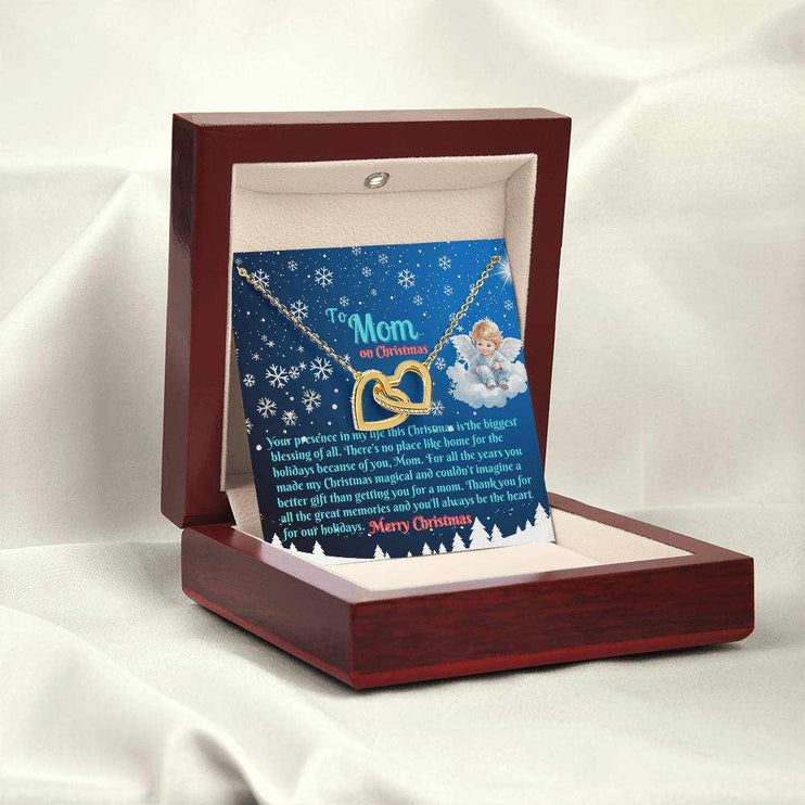 gold interlocking hearts necklace in luxury box on white back drop