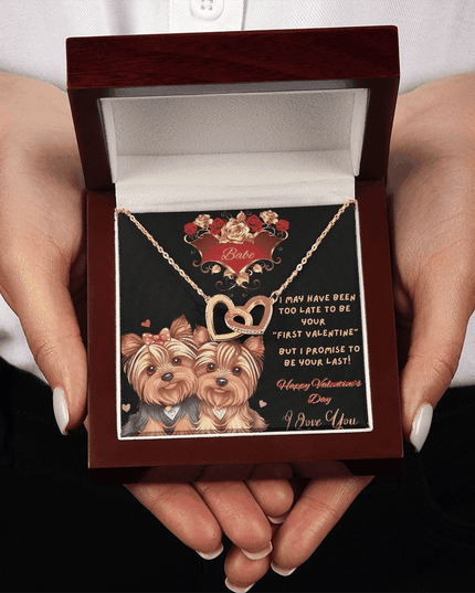yellow gold interlocking hearts necklace in a luxury box in a model's hands