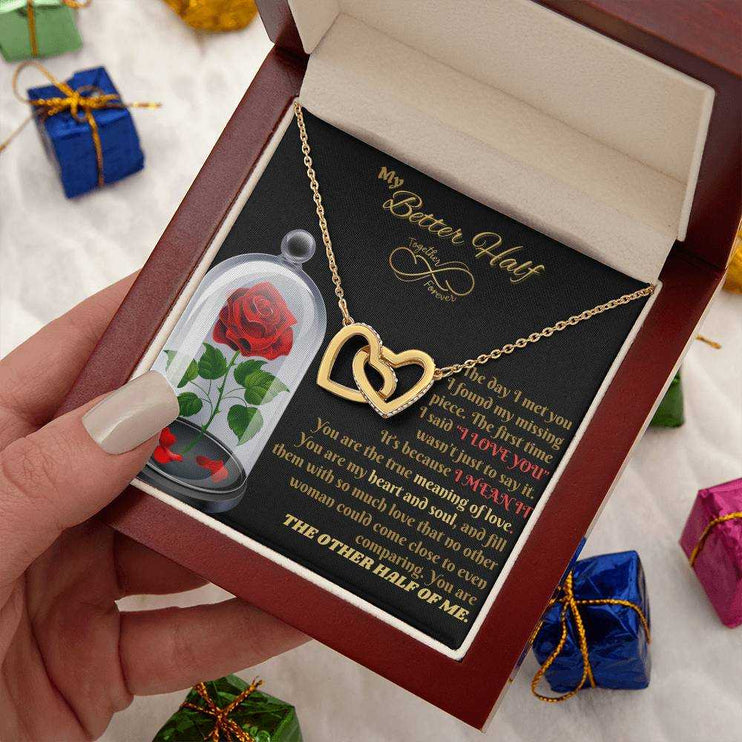 18k interlocking hearts necklace in a luxury box in model's hand