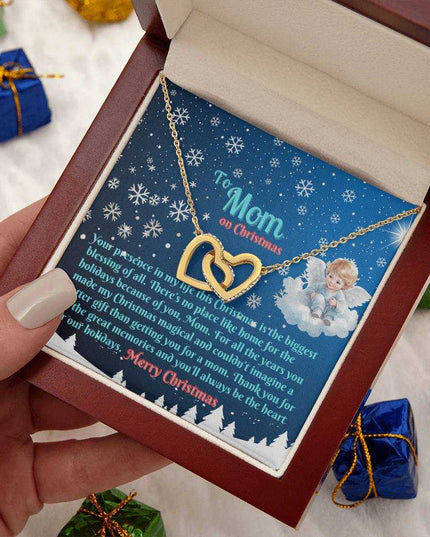 gold interlocking hearts necklace in luxury box in model's hand