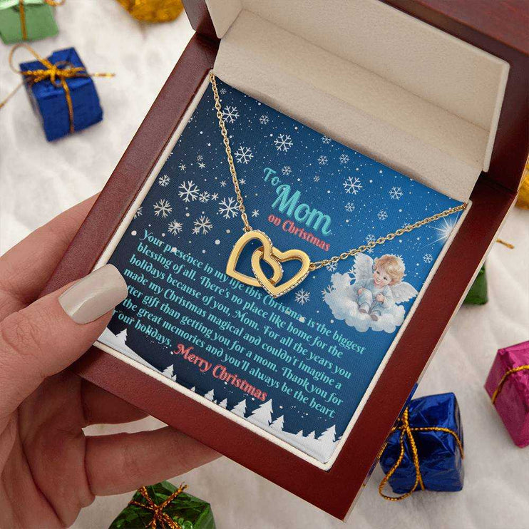 gold interlocking hearts necklace in luxury box in model's hand