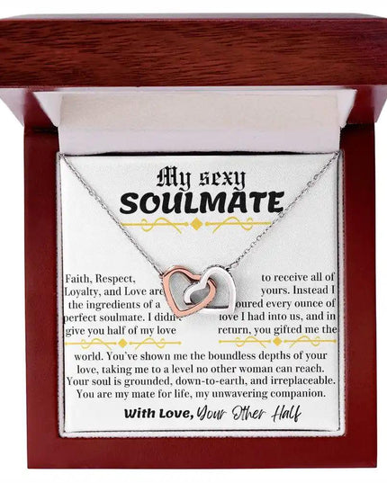 a rose gold interlocking hearts necklace in a mahogany box up close