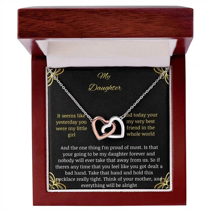 Interlocking Hearts Necklace with a rose gold charm in a mahogany box angle 1