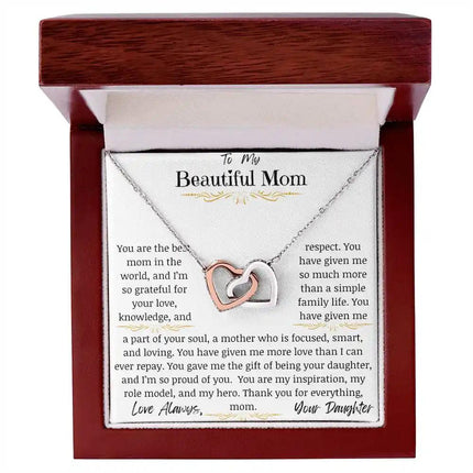 a rose gold interlocking hearts necklace up close in a mahogany box