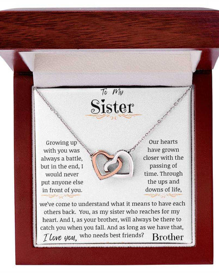 a rose gold interlocking hearts necklace up close in a mahogany box