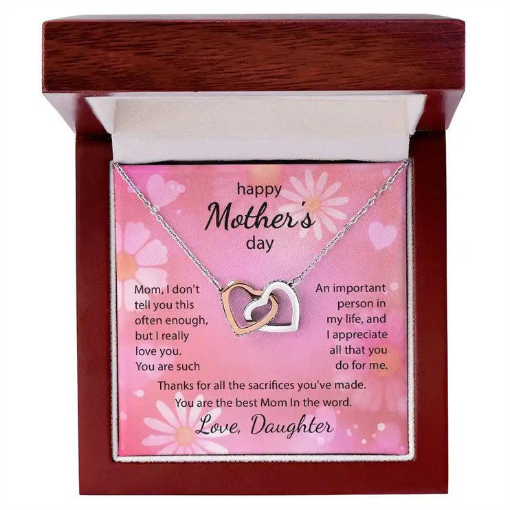  rose gold Interlocking Hearts Necklace up close in mahogany box