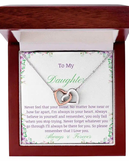 a rose gold interlocking hearts necklace up close in a mahogany box