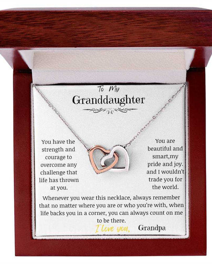 A rose gold interlocking hearts necklace in a mahogany box