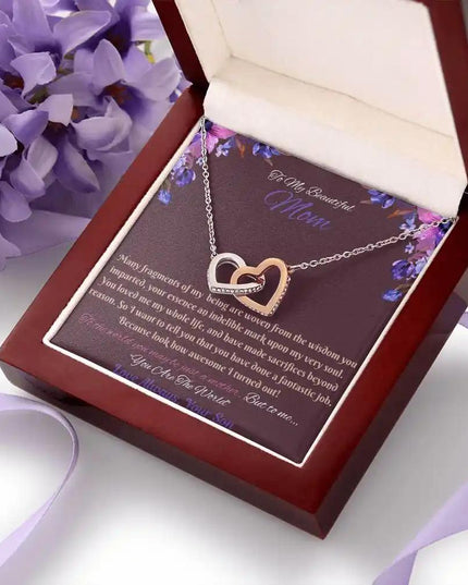 rose gold interlocking hearts necklace in a mahogany box angled right