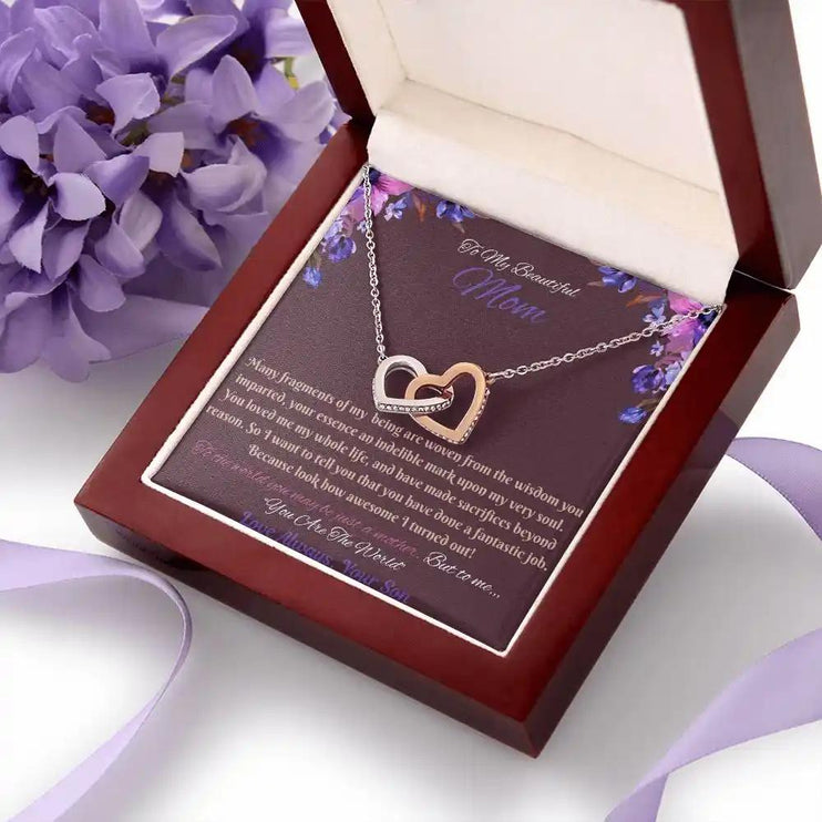 rose gold interlocking hearts necklace in a mahogany box angled right