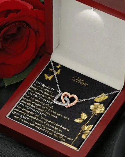 rose gold interlocking hearts necklace in mahogany box angled right