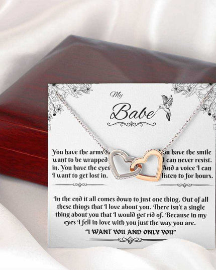 rose gold interlocking hearts necklace on a message card outside of box