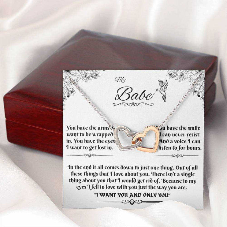 rose gold interlocking hearts necklace on a message card outside of box