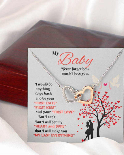 rose gold interlocking hearts necklace outside of a closed luxury box