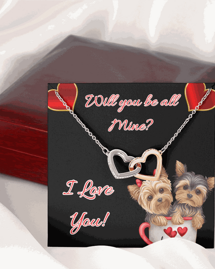 rose gold interlocking hearts necklace and greeting card on a closed box