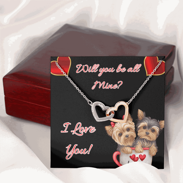 rose gold interlocking hearts necklace and greeting card on a closed box