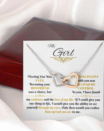 rose gold interlocking hearts necklace on a message card beside a closed luxury box