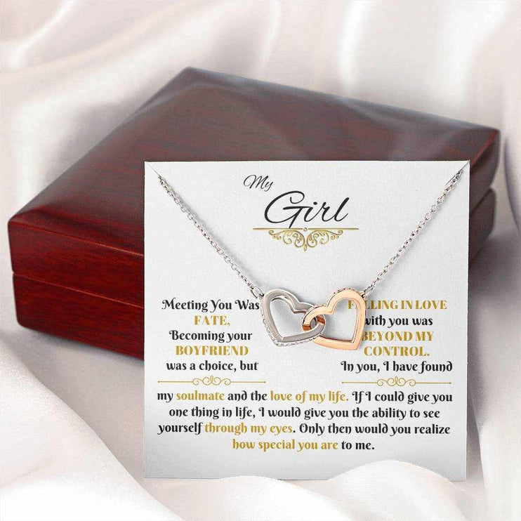 rose gold interlocking hearts necklace on a message card beside a closed luxury box