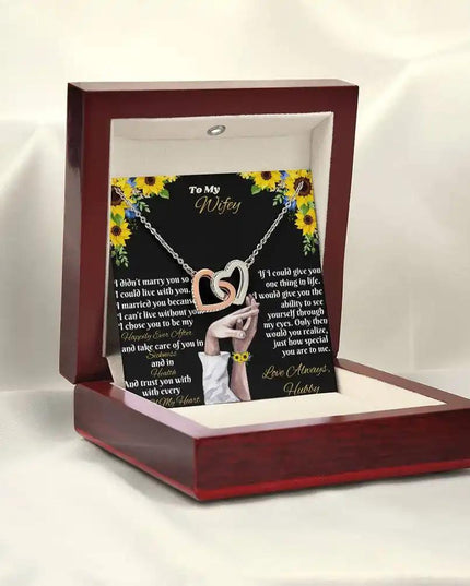 rose gold interlocking hearts necklace in mahogany box angled left