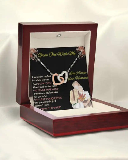 rose gold interlocking hearts necklace in mahogany box on white cloth