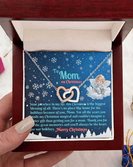 rose gold interlocking hearts necklace in luxury box in model's hands