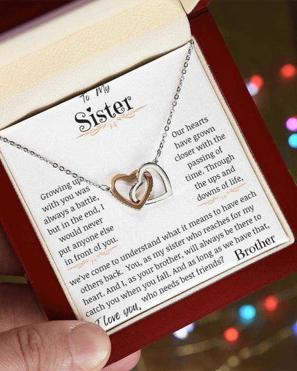 a rose gold interlocking hearts necklace in a mahogany box