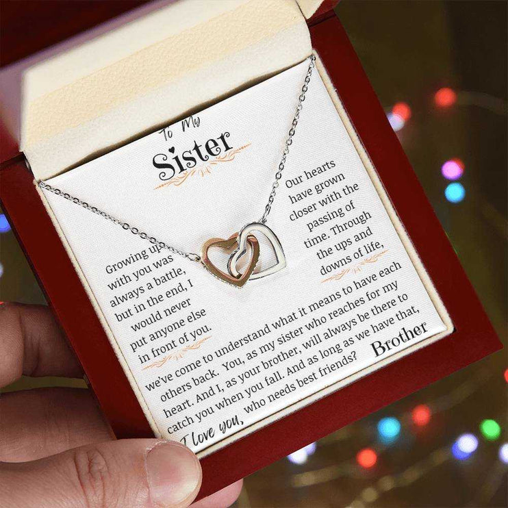 a rose gold interlocking hearts necklace in a mahogany box