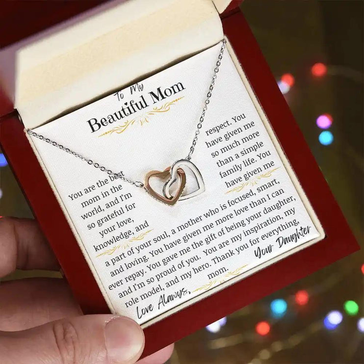 a rose gold interlocking hearts necklace angled left