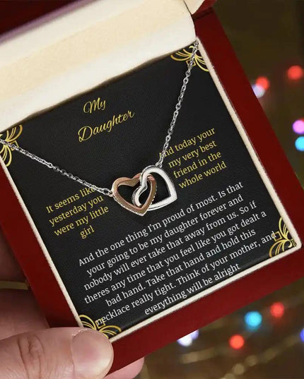 Interlocking Hearts Necklace with a rose gold charm in a mahogany box angle 2