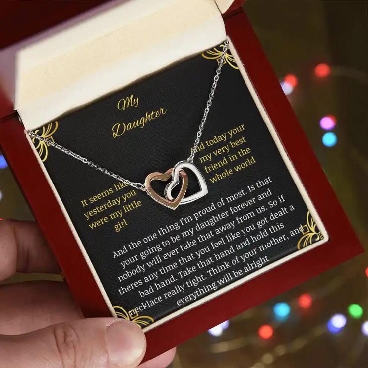 Interlocking Hearts Necklace with a rose gold charm in a mahogany box angle 2