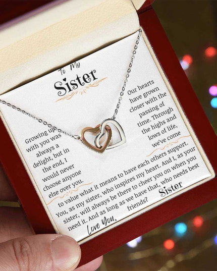 a rose gold interlocking hearts necklace in a mahogany box