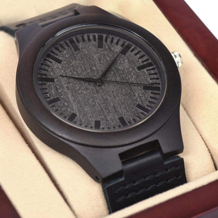 wooden watch in a mahogany box up close of dial
