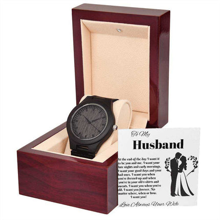 wooden watch in a mahogany box with greeting card leaning on box