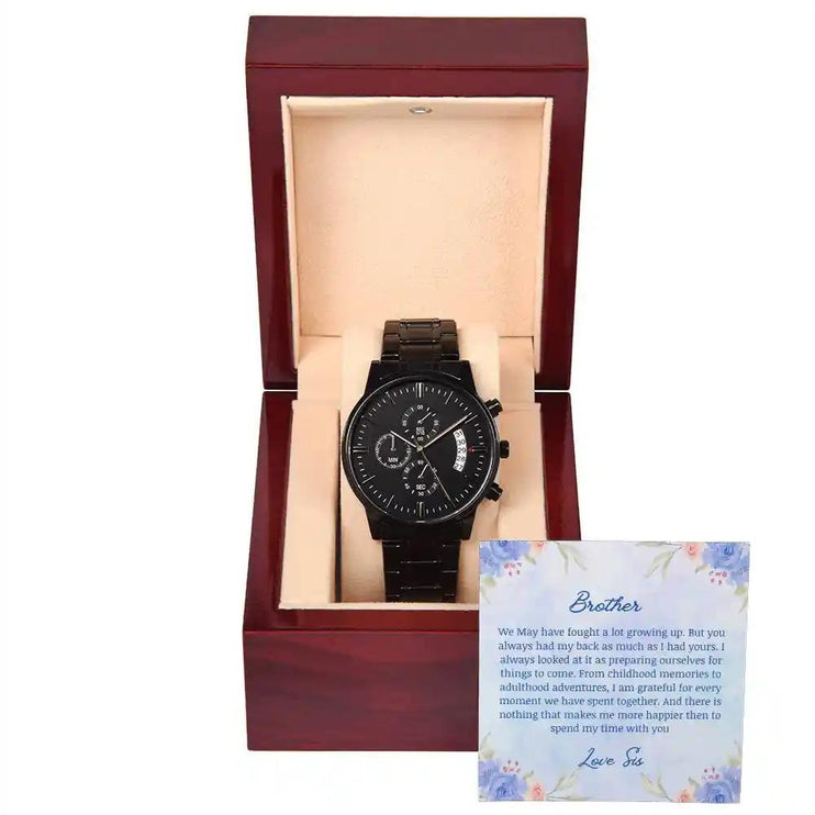 A men's chronograph watch in a mahogany box with a to brother greeting card on the outside of box