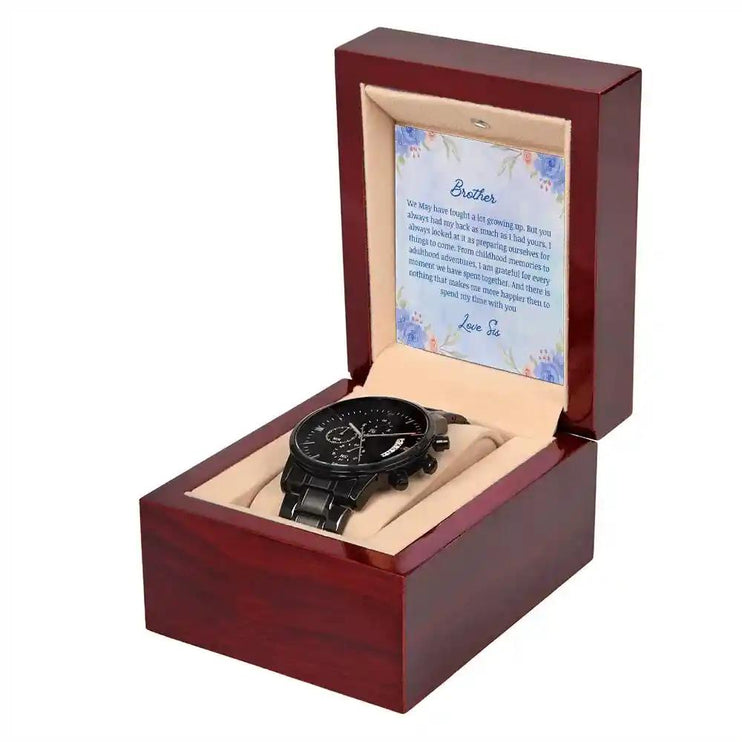 A men's chronograph watch in a mahogany box angled slightly to the left