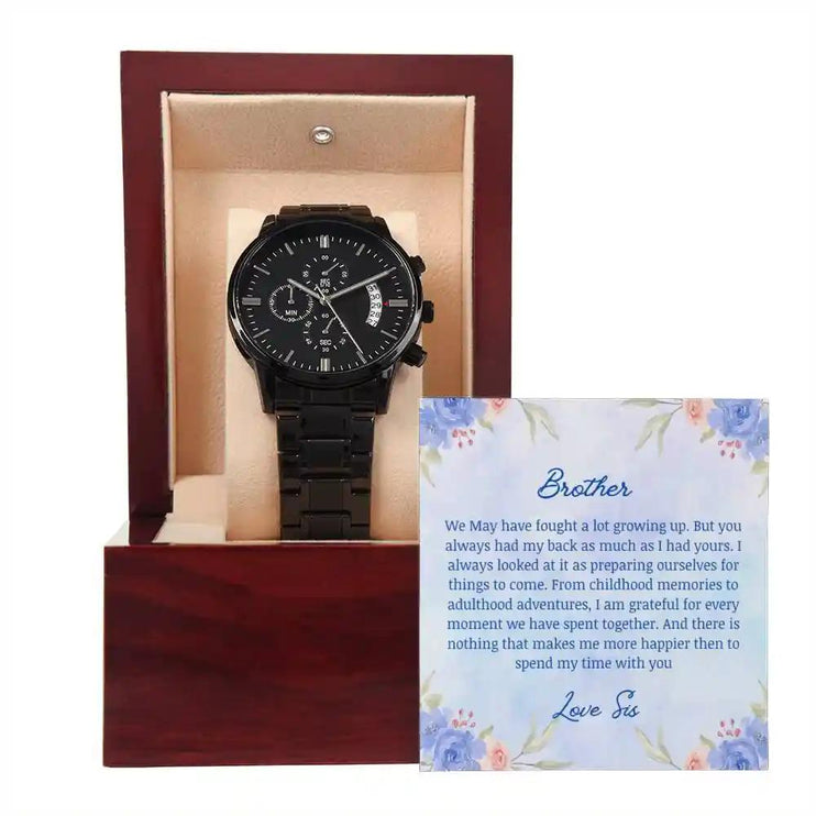 A men's chronograph watch in a mahogany box with a to brother greeting card close up