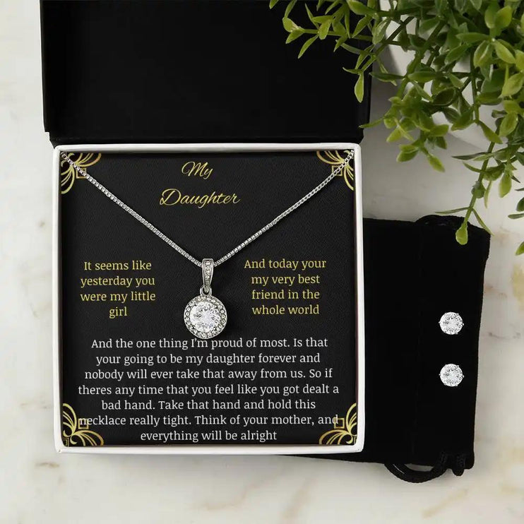 A eternal hope necklace earring set in a two-tone box on a table