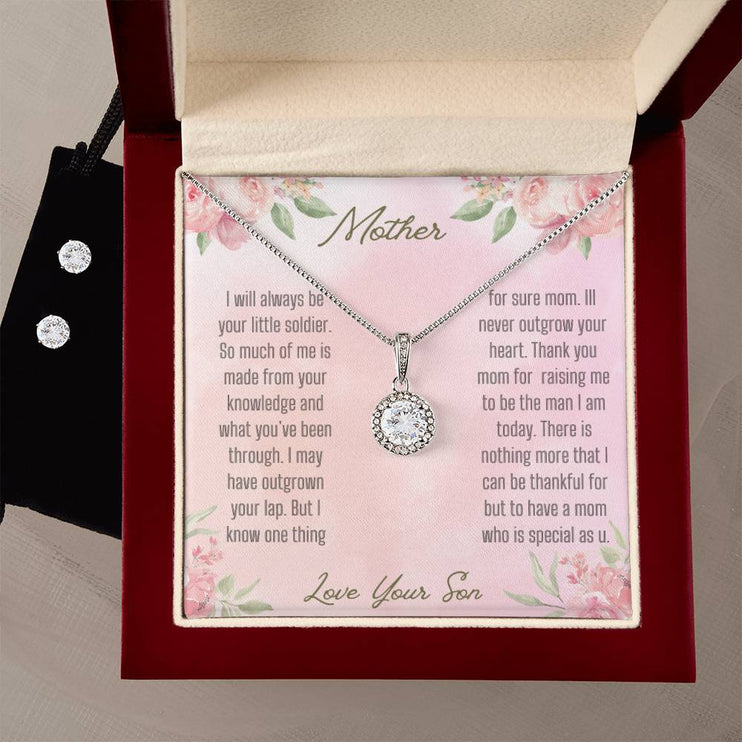 A eternal hope necklace cubic zirconia earring set in a mahogany box with earrings on the left.