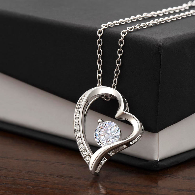 a white gold forever love necklace on a two-tone box