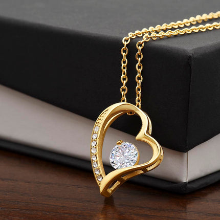 a yellow gold forever love necklace on a two-tone box